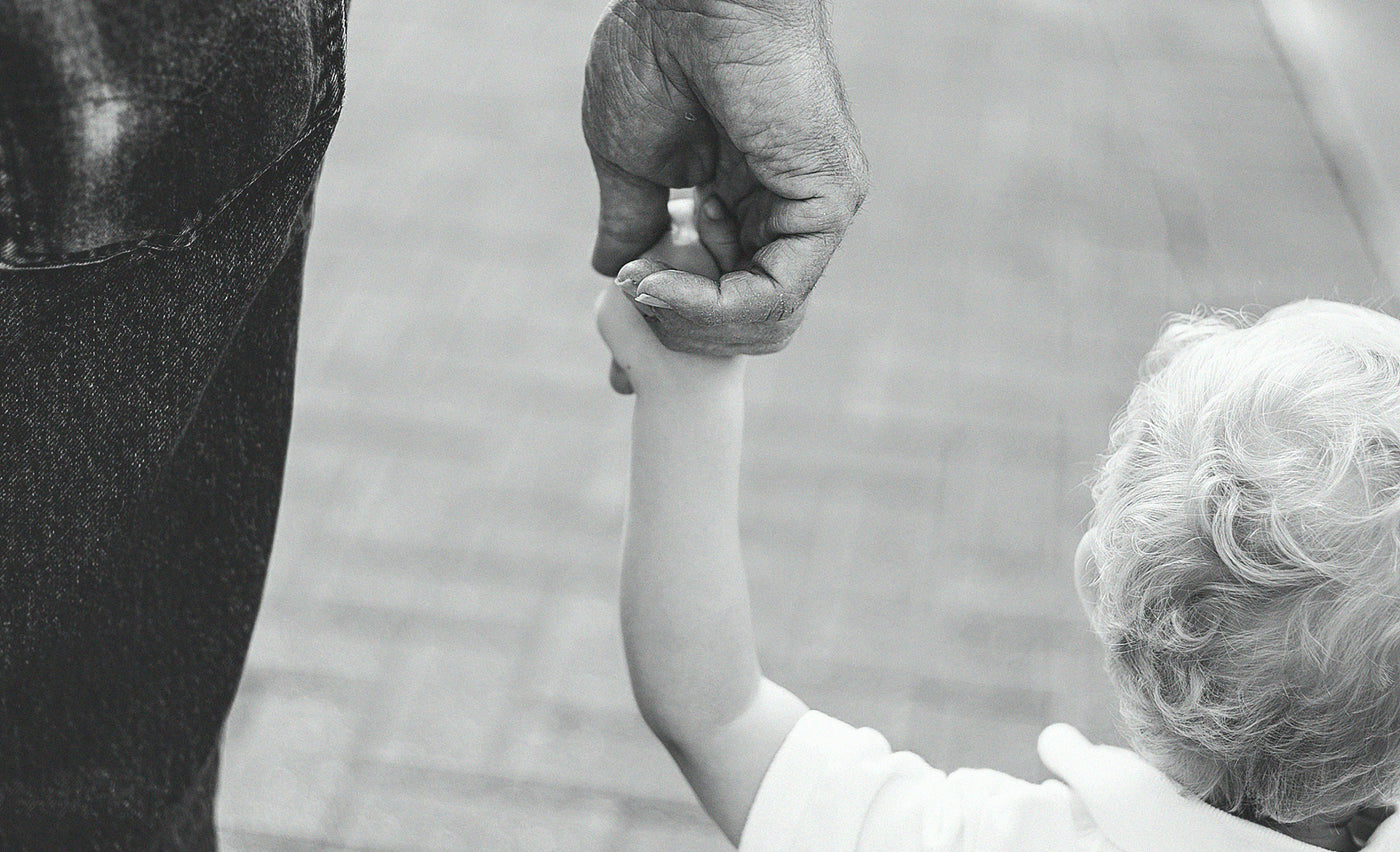 Grandfather holding crandchild's hand